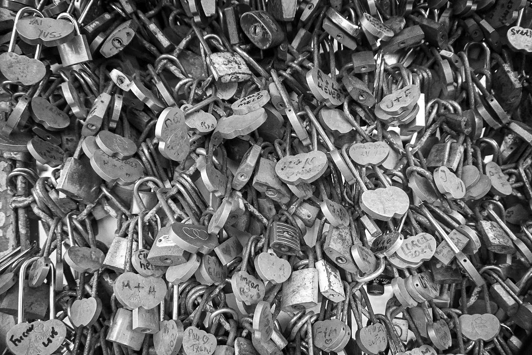 Black and white close-up of hundreds of love locks