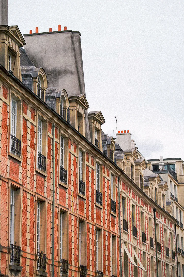 A close view along a red brick and stone Paris facade