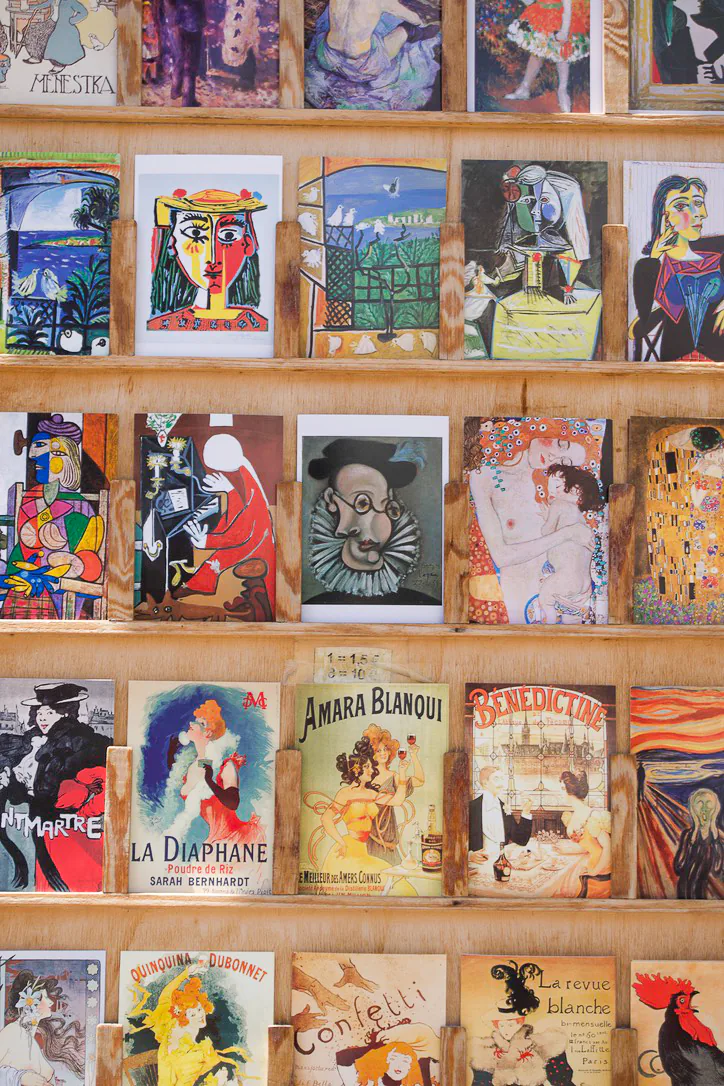 A colorful wall of art postcards in Paris